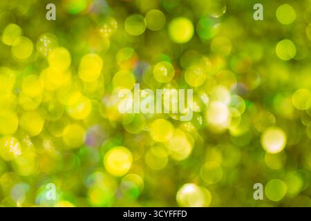Bright yellow bokeh on dark background – festive glitter lights and blurred New Year background Stock Photo