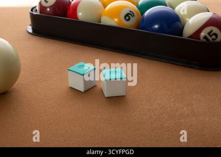 A view of some pool cue chalk on a pool table. Stock Photo