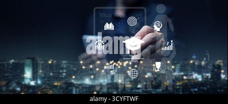 Digital business education concept with hand pointing to graduation cap, representing e-learning, professional development, innovation, and knowledge Stock Photo