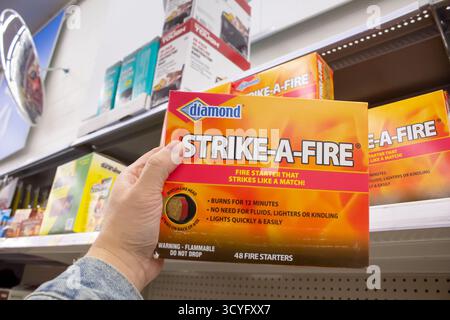 Los Angeles, California, United States - 02-01-2023: A view of a hand holding a package of Diamond Strike-A-Fire, on display at a local retail store. Stock Photo