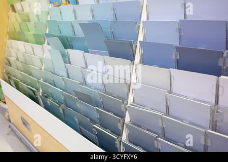 A view of a variety of cool color shade paper samples, seen on a rack in the paint department of a local home improvement store. Stock Photo