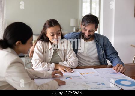 Happy couple engaged in budgeting work together with financial coach Stock Photo