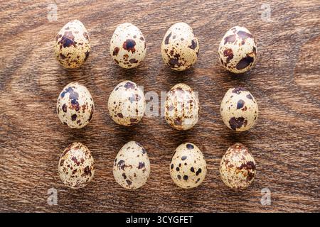 Top view of rows of quail eggs on wooden table Stock Photo