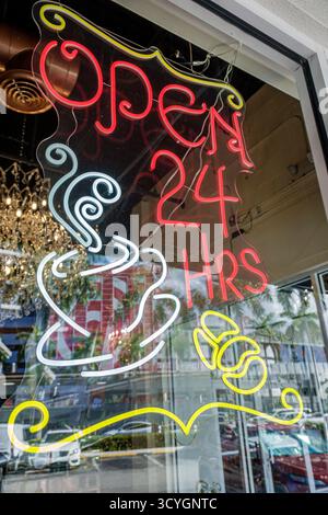 Miami Florida Coconut Grove,South Dixie Highway US Route 1 business,neon sign open 24 hours coffee cup glowing window display,cafe restaurant night se Stock Photo