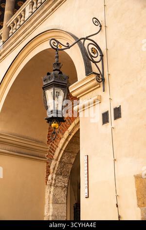 A vintage wrought iron lantern under the vaulted ceiling of an ancient arch Stock Photo
