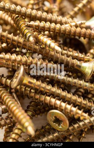 Texture of a pile of wood screws, full screen macro Stock Photo