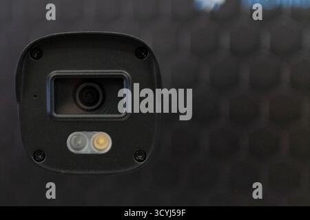 High-tech standalone CCTV surveillance camera displayed at a technology trade show. Isolated close-up of smart home security device with LED indicator Stock Photo