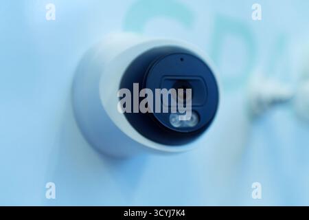 High-tech standalone CCTV surveillance camera displayed at a technology trade show. Isolated close-up of smart home security device with LED indicator Stock Photo