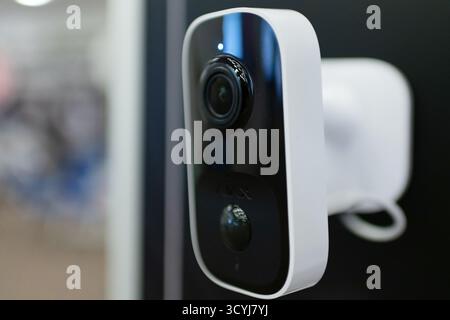 High-tech standalone CCTV surveillance camera displayed at a technology trade show. Isolated close-up of smart home security device with LED indicator Stock Photo