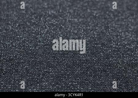 Close-up of dark textured fabric showing knit weave and subtle pattern Stock Photo