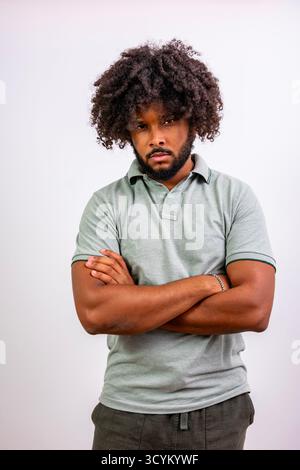 Young black man with curly hair standing confidently, expressing determination Stock Photo