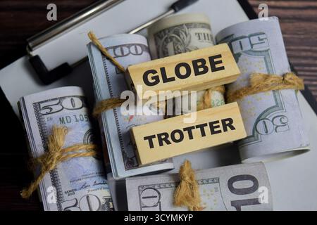 Globe trotter on stacked wooden cubes on the table. Business and finance concept Stock Photo