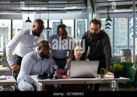 Business colleagues using computers to analyze insights and performance metrics, making projections and data visualization. Employees share reports to improve corporate development. Stock Photo