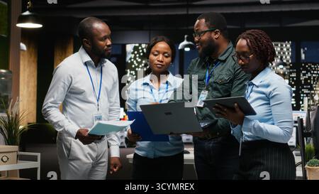 Portrait of business associates collaborating on a project with data insights and financial forecasting, projecting vision to expand enterprise activity. Teamwork to ensure goals. Stock Photo