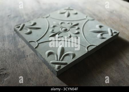 Floor tiles embossed with floral motifs. Gray blend  suitable for outdoor. Stock Photo