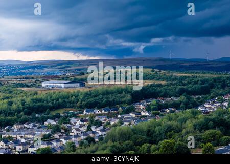 Aerial drone view of Ebbw Vale in Wales with stormy clouds gathering at sunset Stock Photo
