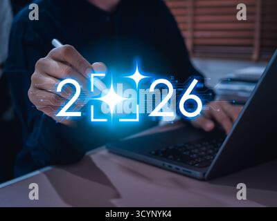 2026 new year number with glowing AI-generated icon highlighted by businessman using digital pen, symbolizing AI automation tools, digital transformat Stock Photo