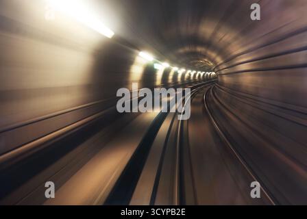 Copenhagen, Denmark. Riding the metro in Copenhagen, Denmark with motion blurred tube lines in tunnel. Abstract with blurred curved lines Stock Photo