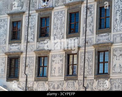 Rich detailing on Palazzo della Carovana facade, Piazza dei Cavalieri, Pisa, Tuscany, featuring sgraffito mythical figures, scrolls, and classical arc Stock Photo