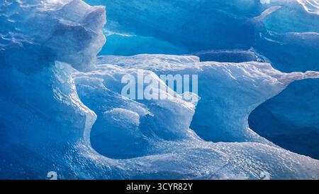 Details of a weathered blue iceberg on the coast of Svalbard. Abstract background texture. Stock Photo