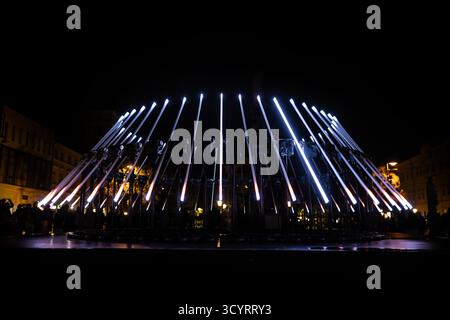 The fascinating night scene captures a modern light installation that dominates the space with a futuristic aesthetic and consists of a number of diag Stock Photo