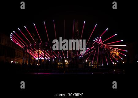 The fascinating night scene captures a modern light installation that dominates the space with a futuristic aesthetic and consists of a number of diag Stock Photo