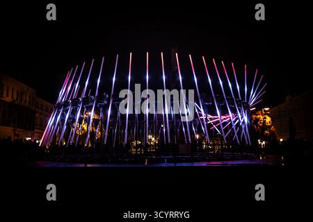 The fascinating night scene captures a modern light installation that dominates the space with a futuristic aesthetic and consists of a number of diag Stock Photo