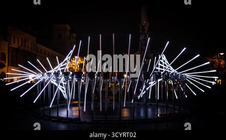 The fascinating night scene captures a modern light installation that dominates the space with a futuristic aesthetic and consists of a number of diag Stock Photo