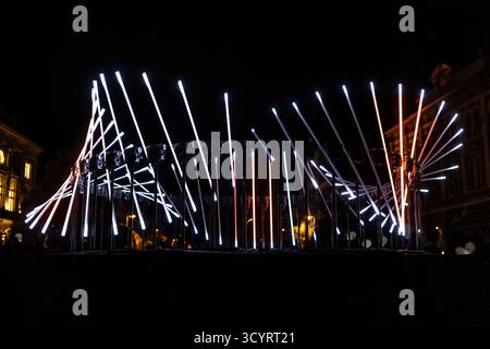 The fascinating night scene captures a modern light installation that dominates the space with a futuristic aesthetic and consists of a number of diag Stock Photo