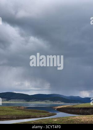 Landscape storm clouds over lake. thunderclouds over mountains and lake Stock Photo