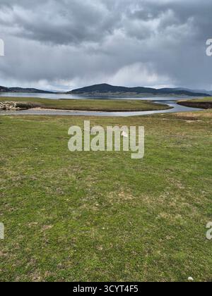 Landscape storm clouds over lake. thunderclouds over mountains and lake Stock Photo