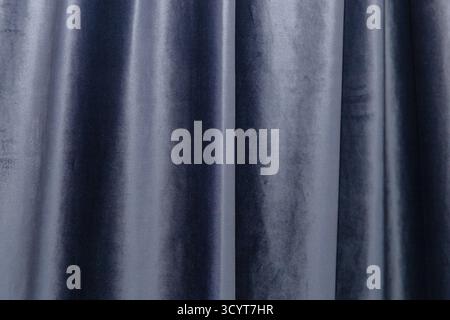 Soft dark gray velvet curtain with smooth folds and elegant texture for interior design background. Stock Photo