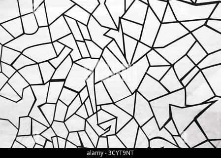 Black polygonal patterns in the form of lines of different geometric shapes on white glass Stock Photo