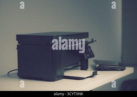 The multi-function laser printer in the home office. Stock Photo