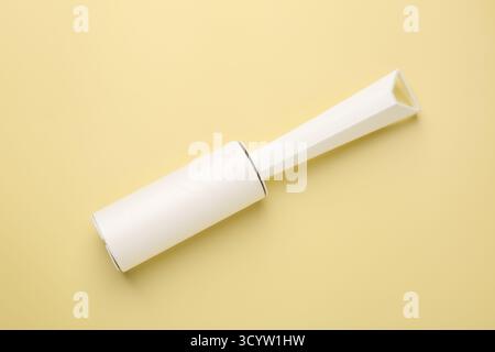 One lint roller on yellow background, top view Stock Photo