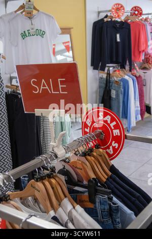 Barbour clothing sale on rails in a shop in Bude, Cornwall, UK Stock Photo