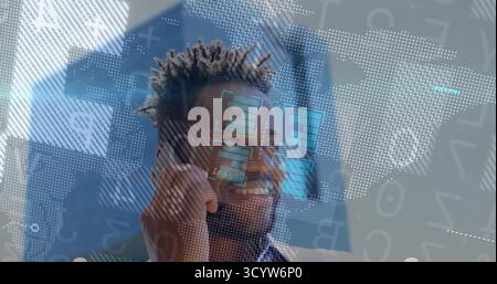 Analyzing male wearing glasses, blazer interacting with laptop at office desk with overlay graphics Stock Photo