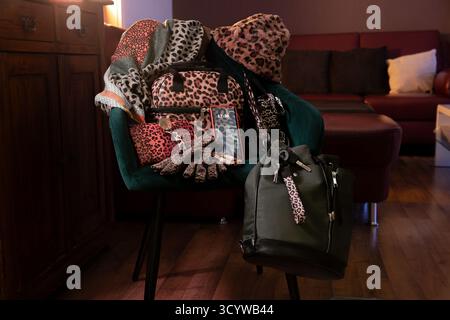 Predator wardrobe with leopard print on bags, scarves, hats, shoelaces, and gloves, including smartphone screen protectors as a statement of feminine Stock Photo