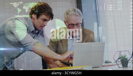 Leaning two colleagues working on laptop at office with succulent terrarium, paperwork, eyeglasses Stock Photo