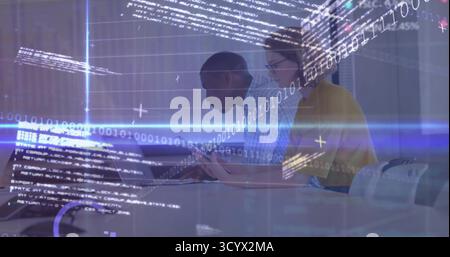 Collaborating software engineers coding at conference table, with laptop tablet pen code overlay Stock Photo