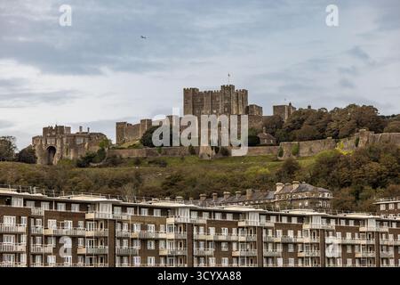 Dover Castle on a hill with Henry II's Great Tower at its centre above the sea front buildings in the town of Dover, Kent, England, UK, Europe Stock Photo