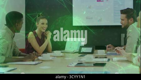 Collaborating four professionals analyzing charts in meeting room, with laptops and network overlay Stock Photo