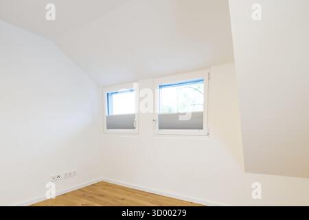 Bright room under the sloping roof with two windows and pleated blinds, house renovation, air conditioning, Metzingen, Germany Stock Photo