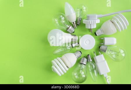 A set of different types of LED lamps isolated on a green background. Energy-saving lamps, a flashlight in the center Stock Photo