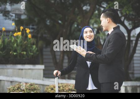 Young entrepreneurs talking outdoor, business travelling Stock Photo