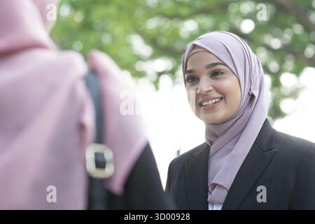 Beautiful Muslim business woman talking and smile Stock Photo