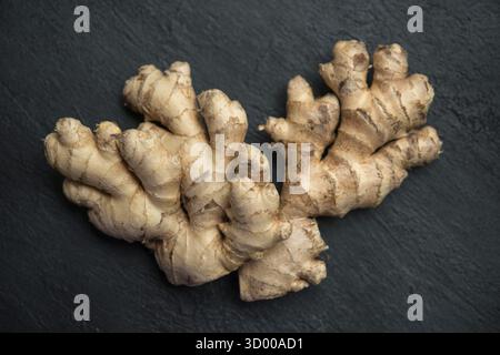 Flat lay fresh raw ginger root on dark background Stock Photo
