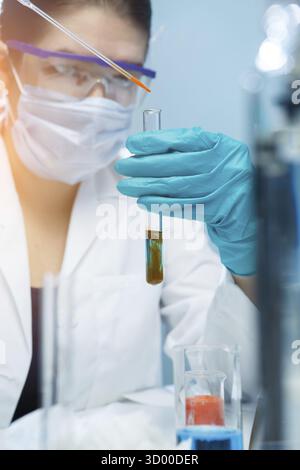Young scientist handling chemical agents in laboratory Stock Photo