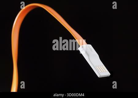 Orange cord on isolated black empty background Stock Photo
