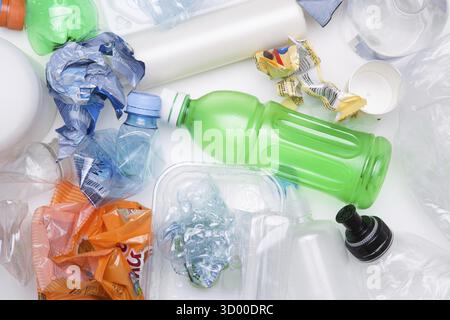 Crumpled PET bottles for recycle on white table Stock Photo